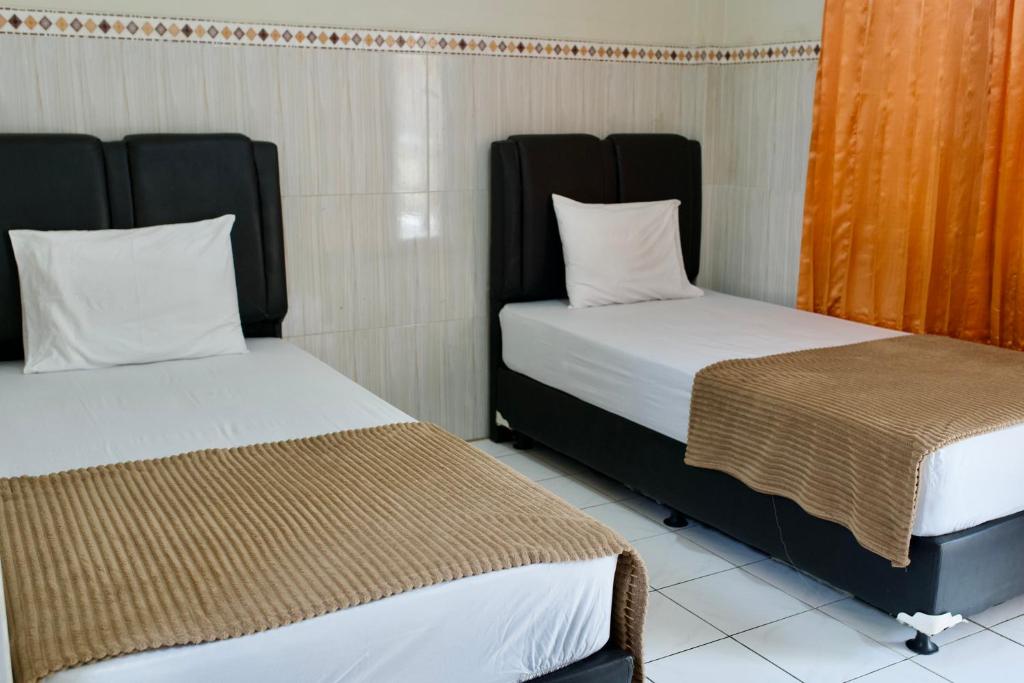 Katil atau katil-katil dalam bilik di Garuda Setia Hotel