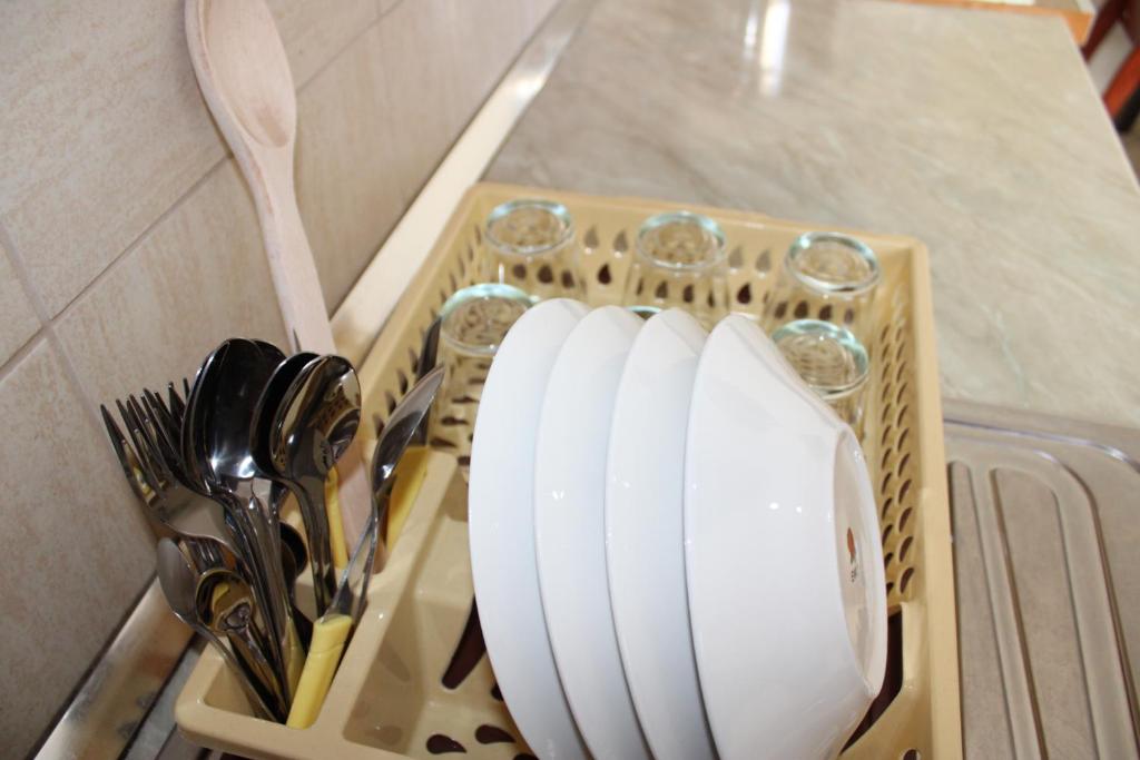 a tray with knives and utensils on a counter at Crew Hostel Tirana in Tirana