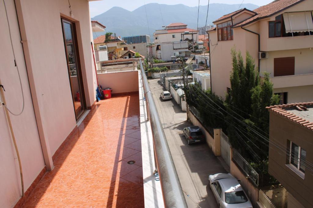 an apartment balcony with a view of a street at Crew Hostel Tirana in Tirana