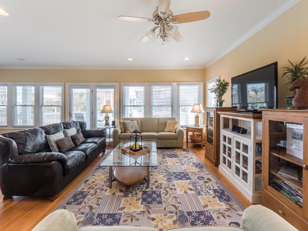 a living room with a couch and a tv at 1 Pleasure Island in Kure Beach