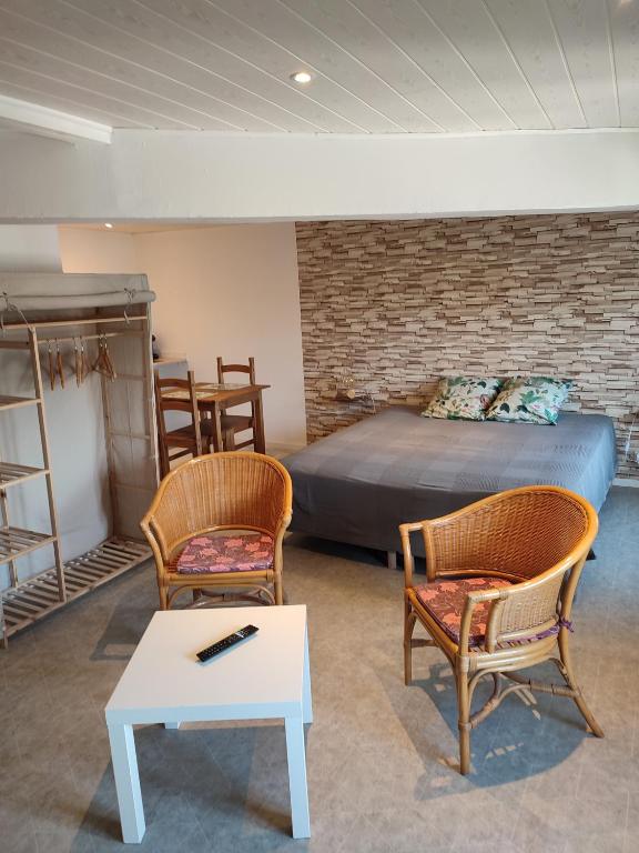 une chambre avec un lit, deux chaises et une table dans l'établissement le mas rocamour, à Roquemaure