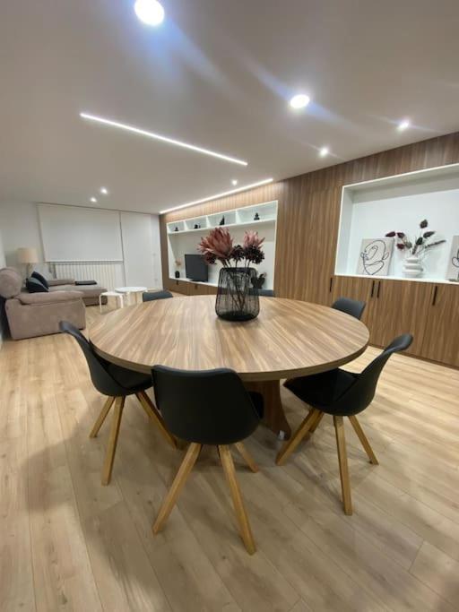 a table in a room with chairs and a couch at Apartamento Miño in Tui