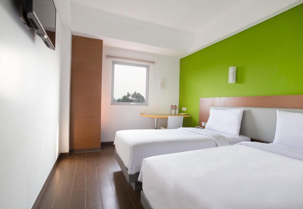 Postel nebo postele na pokoji v ubytování Amaris Hotel Citra Raya – Tangerang