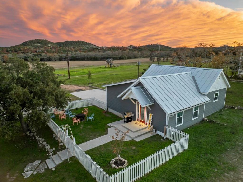 an overhead view of a blue house with a fence at Kingsby Cottage - 1 Bedroom w Mountain views in Boerne