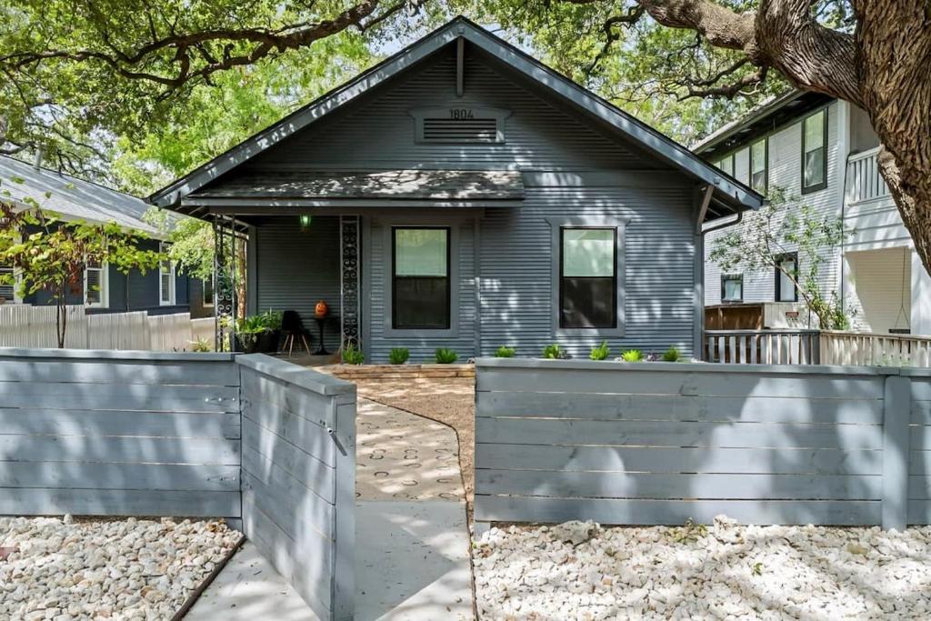 a house with a fence in front of it at Retro Austin Home S Congress Ave in Austin