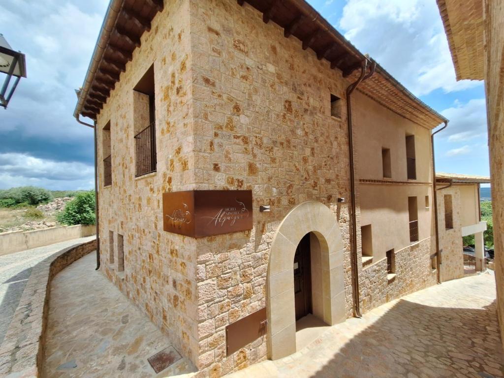 an external view of a stone building with a window at Hotel Vinoteca Alquezar - Adults Only - in Alquézar