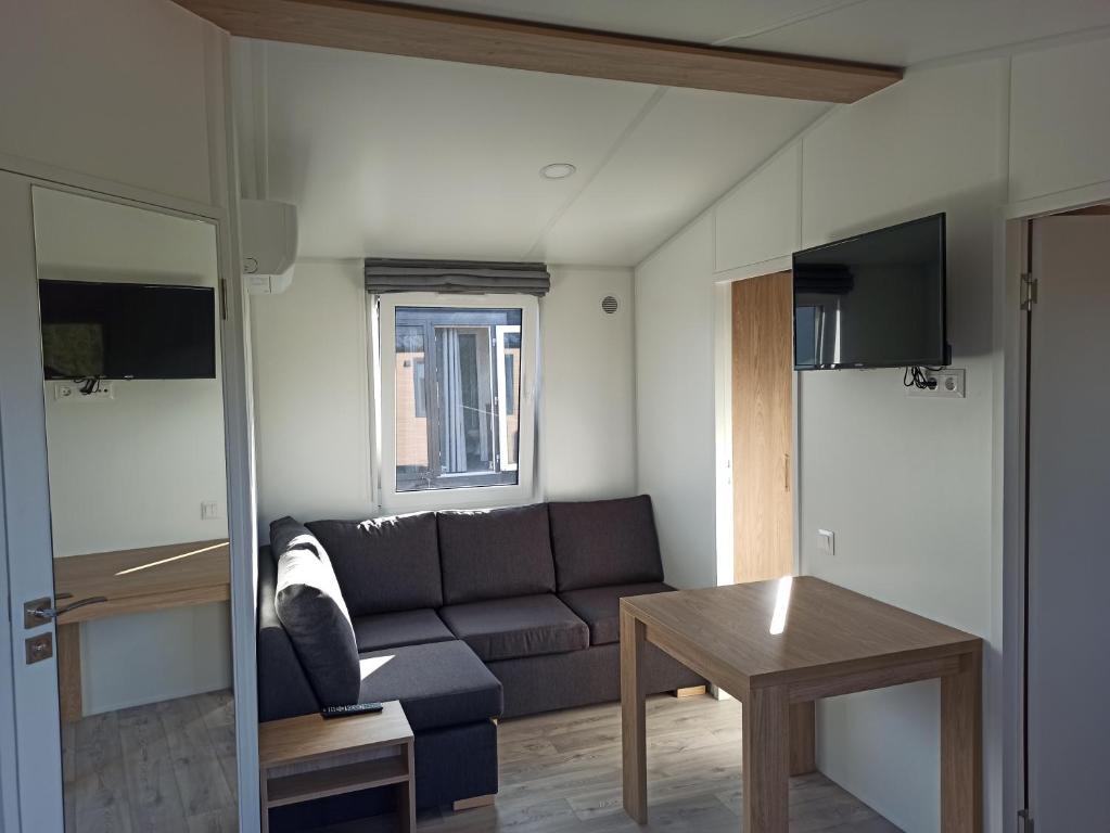 a living room with a couch and a table at Ferienchalet Neunburg vorm Wald Urlaub auf dem Bauernhof in Ebersdorf