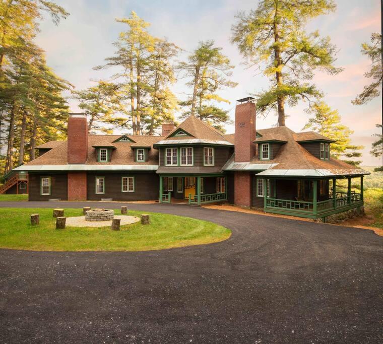 a large red brick house with a driveway at Quietude - A 60-Acre Historic Mountain Estate with 10 bedrooms in Tuftonboro