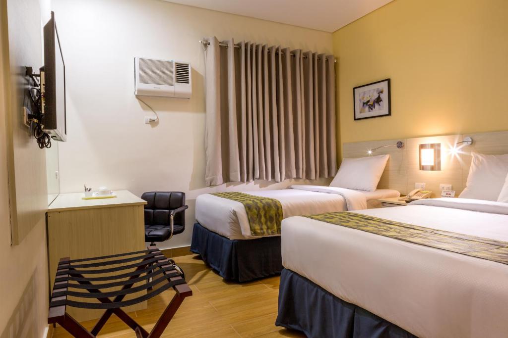Postel nebo postele na pokoji v ubytování Hamersons Hotel Cebu