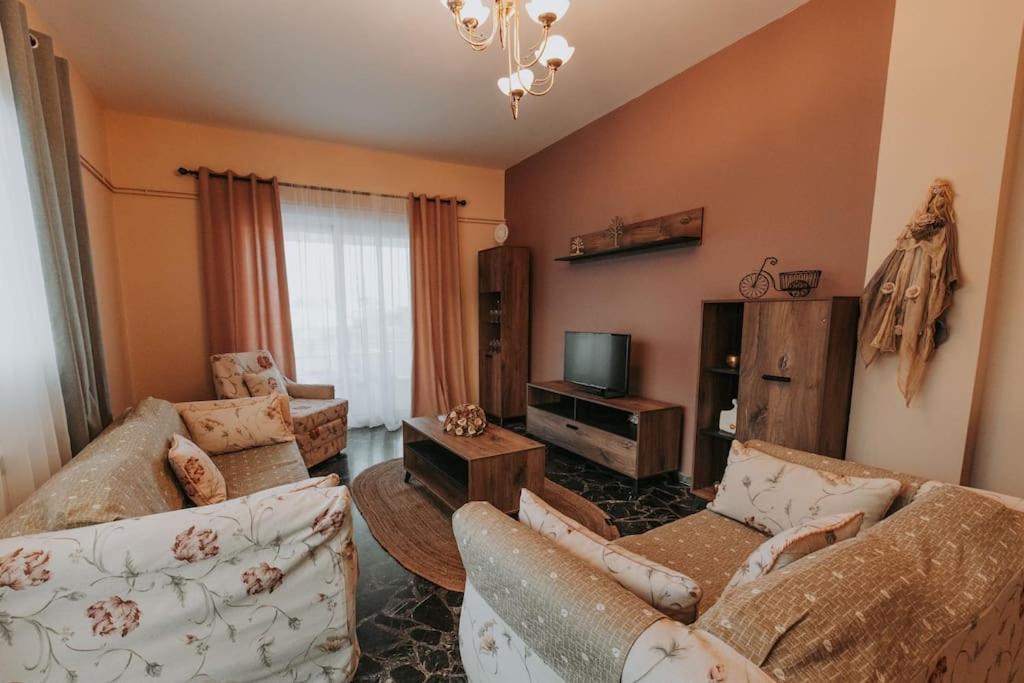 a living room with two couches and a tv at tony's house in Kámpos
