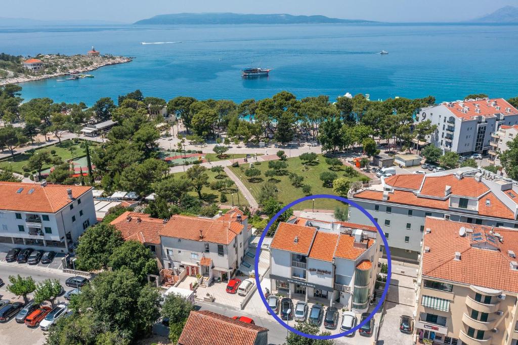 an aerial view of a city with a blue circle at Villa Rubcic in Makarska