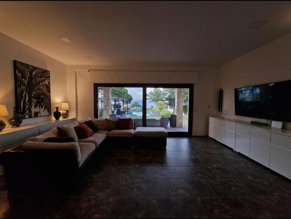 A television and/or entertainment centre at Villa Musa with private pool
