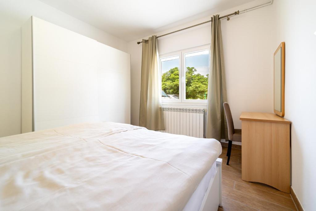 Postel nebo postele na pokoji v ubytování Apartmani Višnja