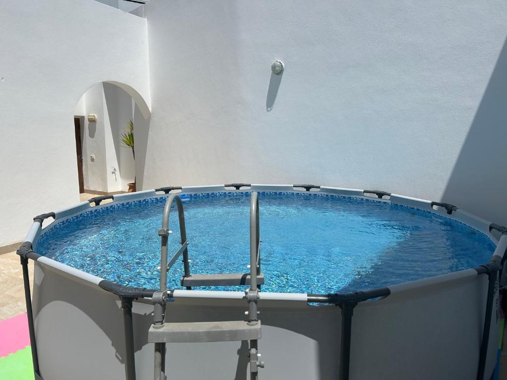 a hot tub with a chair in a room at Piscina en Herrería 18 in Conil de la Frontera
