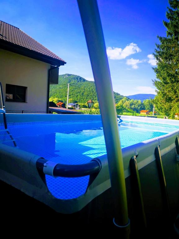 a swimming pool with a view of the mountains at Apartman Enjoy in Bihać