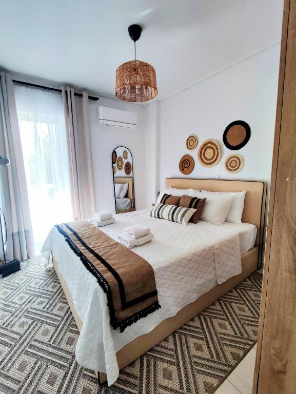 a bedroom with a large bed and a large window at Casa Di Penny 1 in Kyparissia