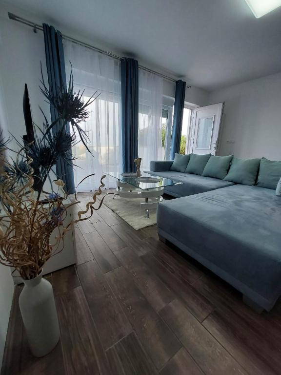 a living room with a bed and a couch and a table at Apartments Mišković in Vir