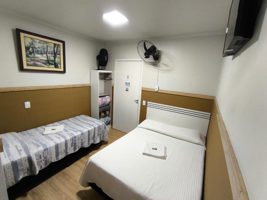 Ένα ή περισσότερα κρεβάτια σε δωμάτιο στο URANO BUSINESS HOTEL