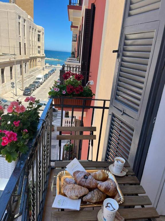 a balcony with a tray of pastries on a table at Mariamora Apartment in Bari