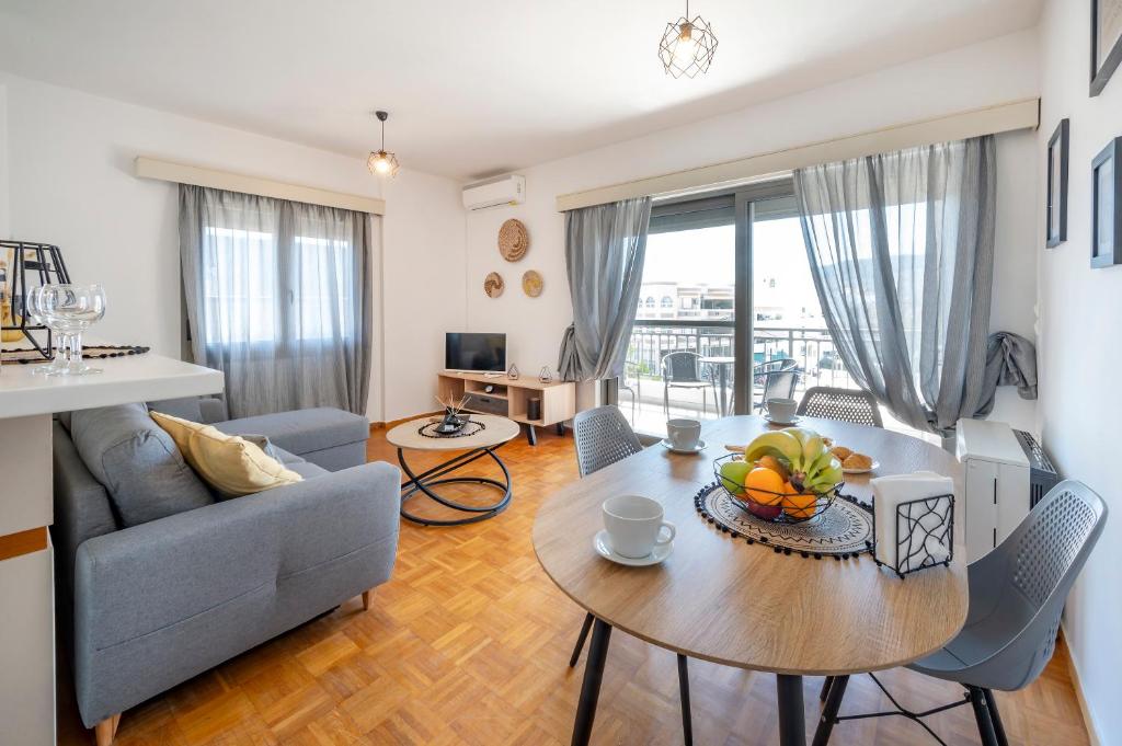 a living room with a table and a couch at City Calm House in Platánion