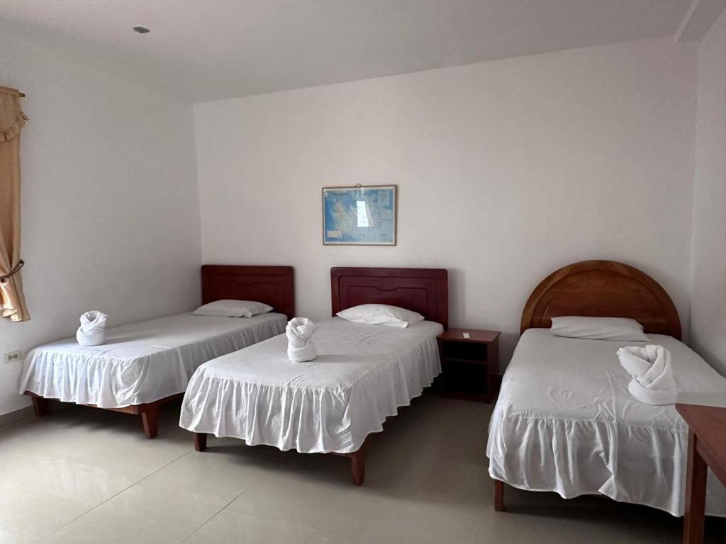 Postel nebo postele na pokoji v ubytování Hostal Insular