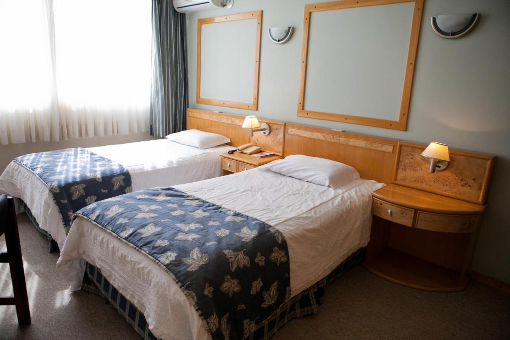 Postel nebo postele na pokoji v ubytování Atalaia Palace Hotel
