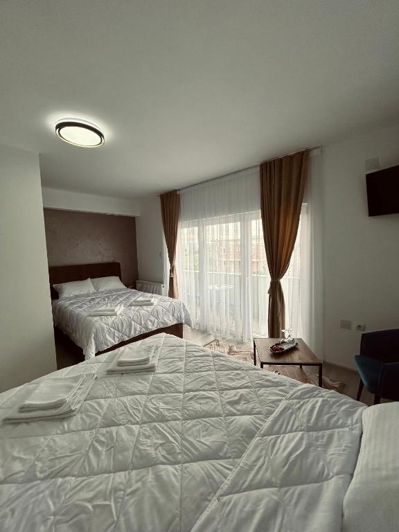 Postel nebo postele na pokoji v ubytování GreenHill Apartments
