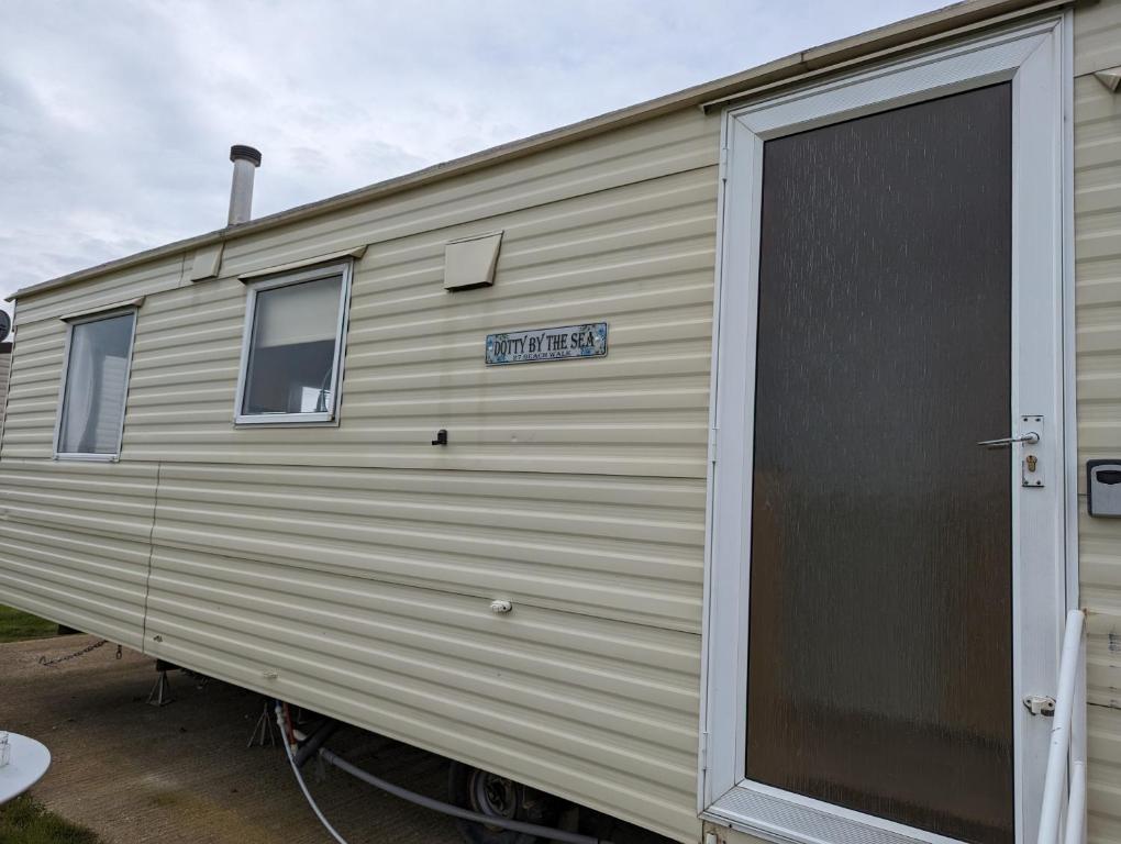 Dotty By The Sea, 27 BW, St Osyth Beach - price is whole caravan with field views - Housity