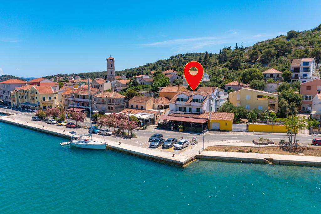 an aerial view of a town with a red heart sign at Apartments by the sea Tisno, Murter - 815 in Tisno