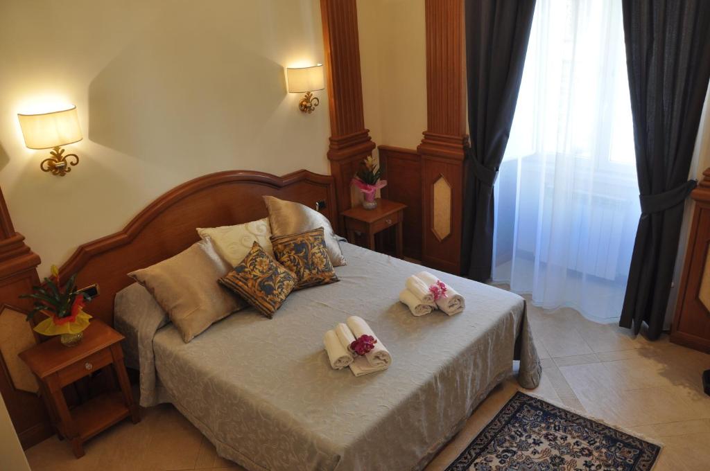 a bedroom with a bed with two towels on it at Rome Imperial Crown in Rome