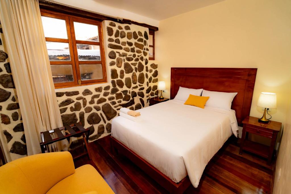 Postel nebo postele na pokoji v ubytování NUNA SUMAQ Hotel