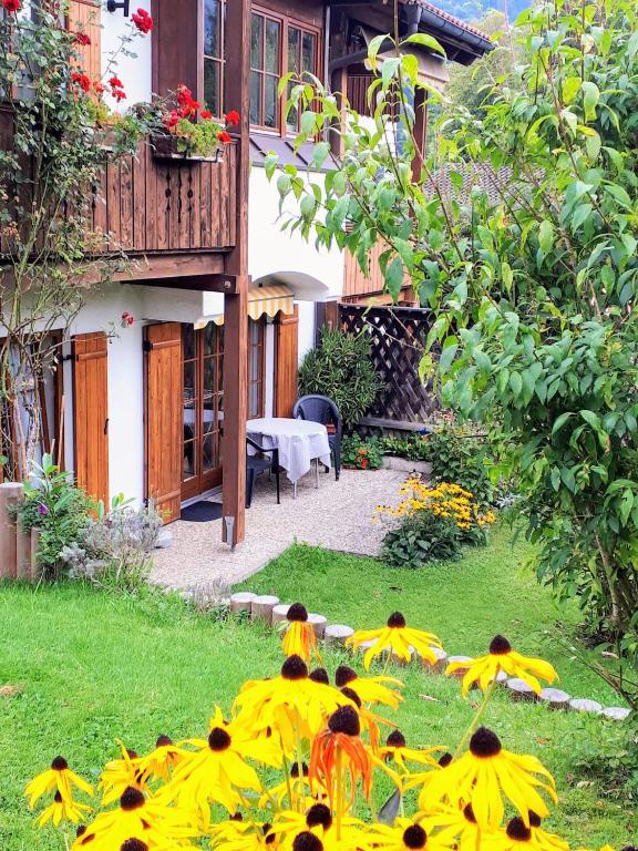 a garden with yellow flowers in the grass at Ferienwohnung Hinterstoißer in Berchtesgaden