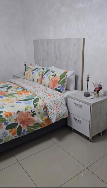 a bedroom with a bed and a dresser with a bed sidx sidx at Durban Overport Halaal Accomodation 5S in Durban