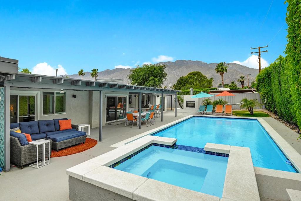 an image of a house with a swimming pool at Teal and Tangerine Retreat - Meredith Lodging in Palm Springs