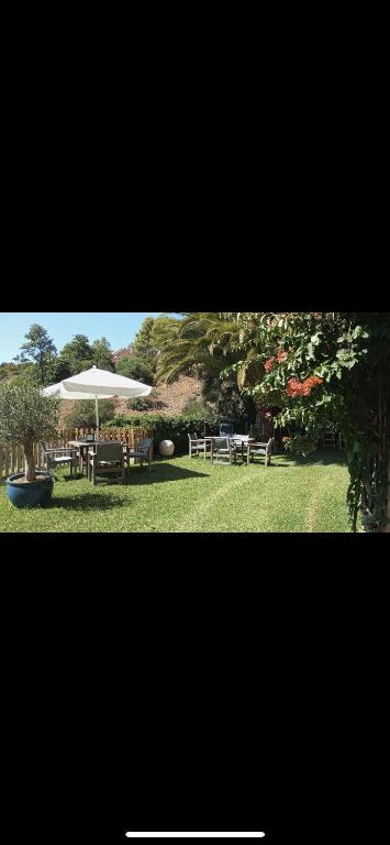 a patio with an umbrella and a table and chairs at Finca vista de la roca in Estepona