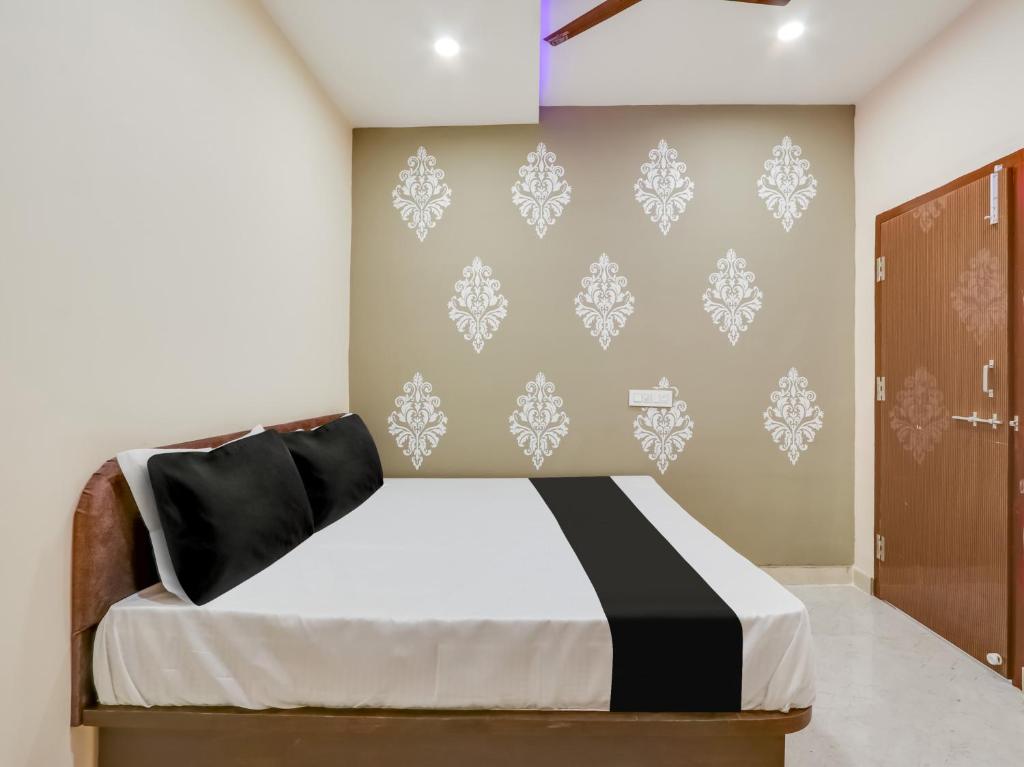 - une chambre avec un lit et un mur dans l'établissement OYO Flagship BSS INNS HOTELS, à Warangal