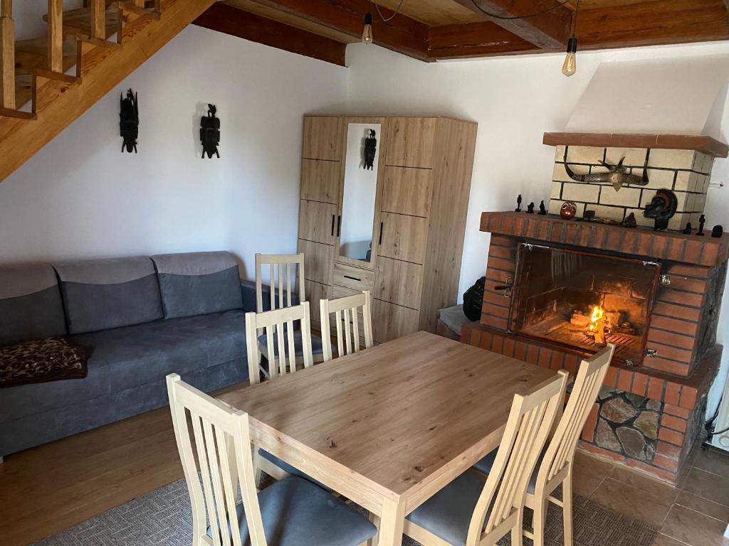 a living room with a table and a fireplace at FULEDA Holiday Home in Fuleda