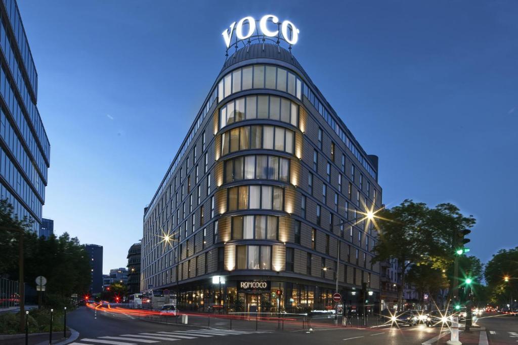 a building with a sign on the top of it at voco Paris - Porte de Clichy, an IHG Hotel in Clichy