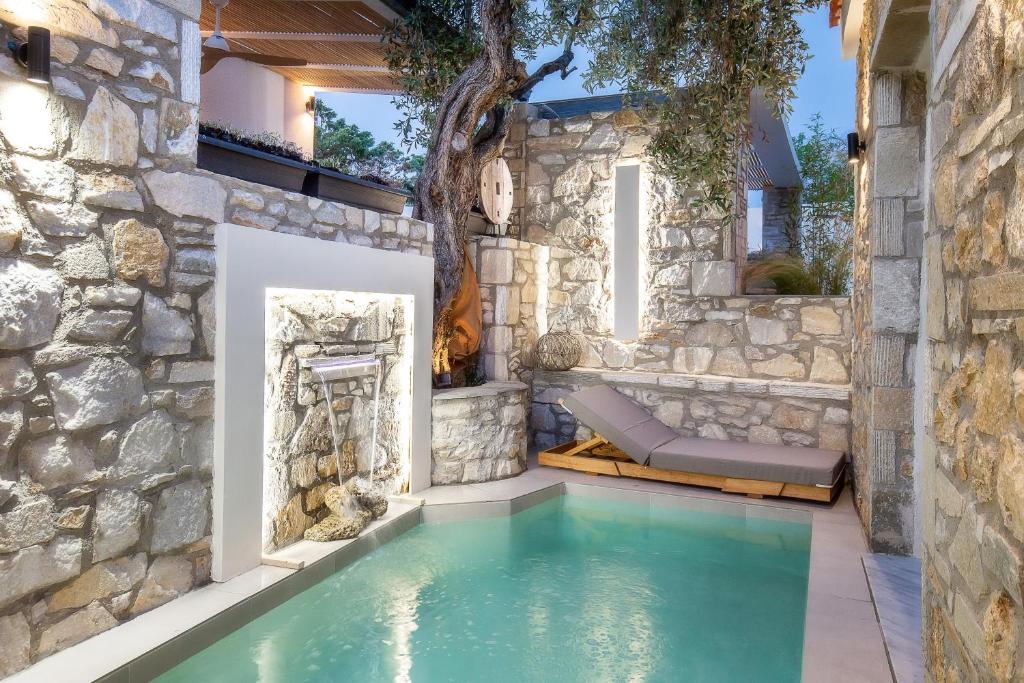 a pool in the middle of a stone house at Stone House Maria in Skala Marion