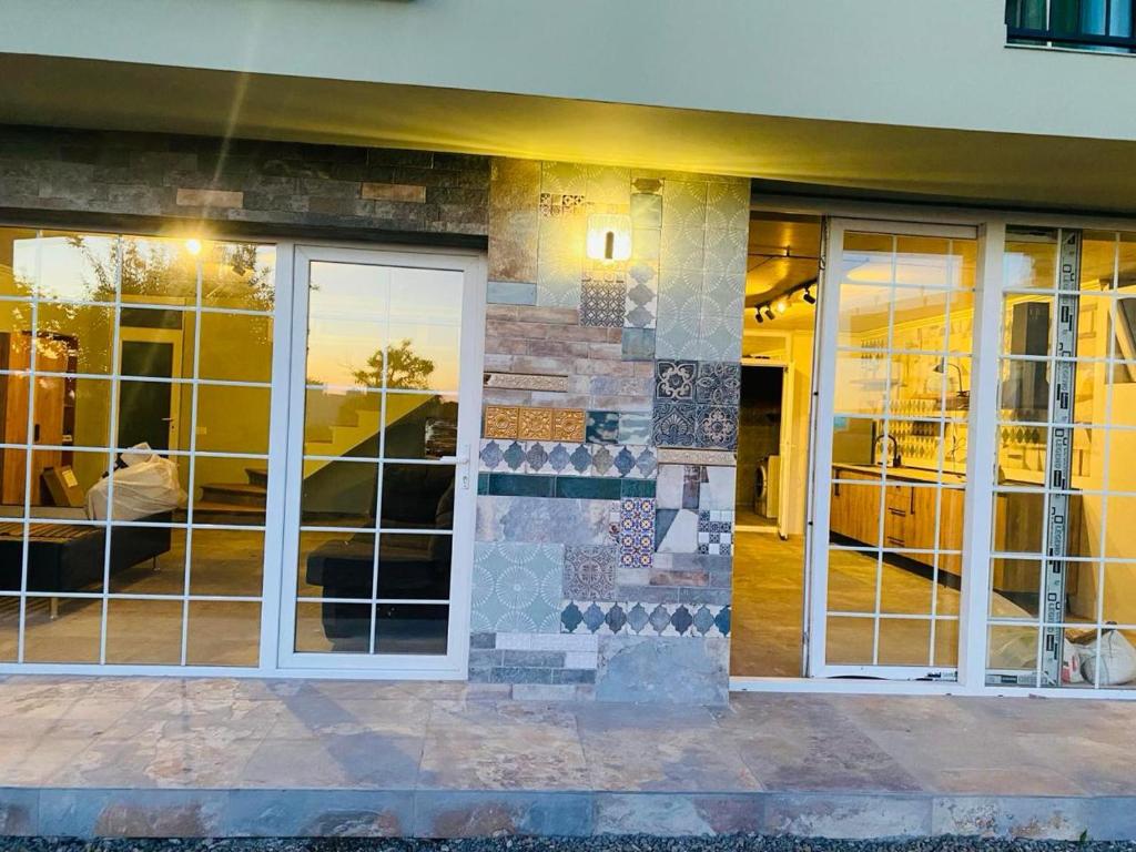 a building with glass doors and windows on it at Sweet Lemon in Batumi