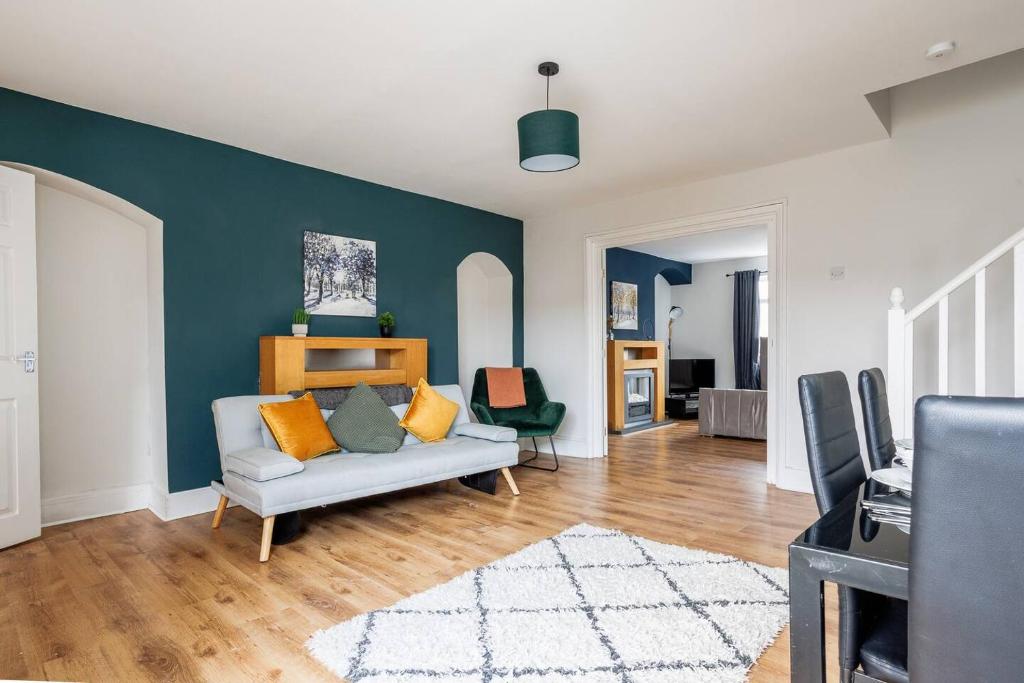 a living room with a couch and a blue wall at Enjoy a spacious 3 BR home in Sunderland