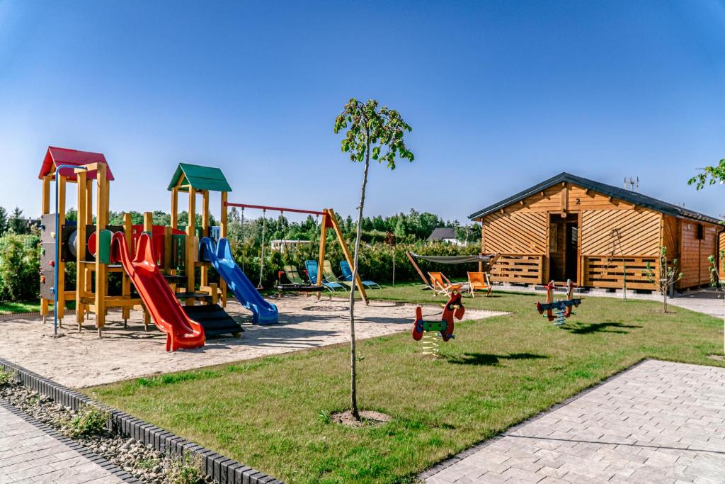 a park with a playground with a slide at Morska Cisza in Pleśna