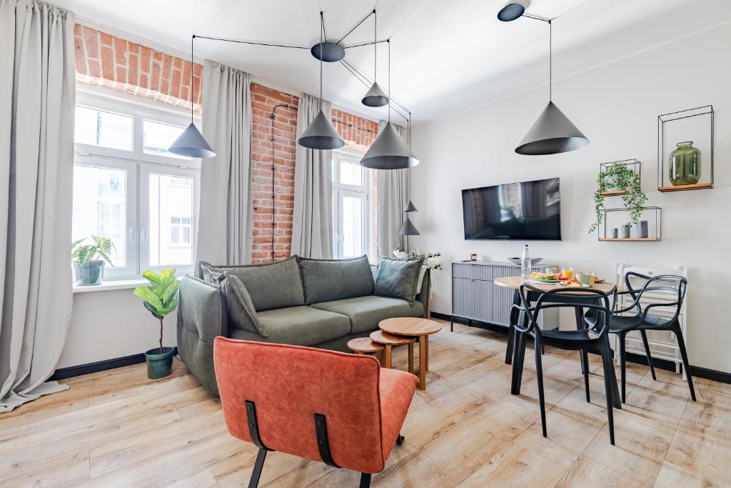 a living room with a couch and a table at Mińska Apartament in Warsaw