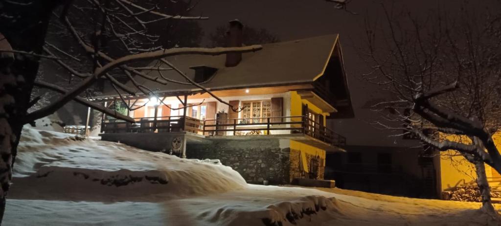 a house in the snow at night at Chalet Le Loup Bouquetin in Saint-Colomban-des-Villards