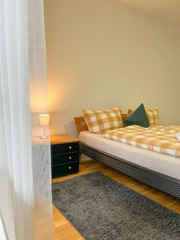 a bedroom with a bed and a nightstand with a bed sidx sidx at Apartments am Wall in Bremen