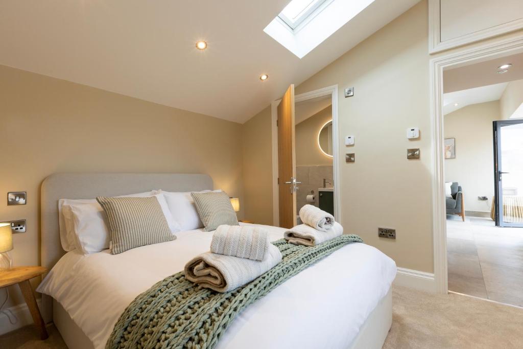 a bedroom with a bed with towels on it at The Old Cutter Shed in Whitby