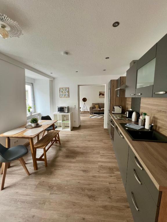 a kitchen with a table and a dining room at Ferienwohnung Altstadtherz in Tirschenreuth