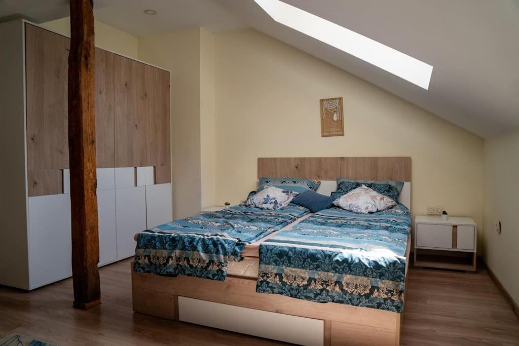 a bedroom with a bed with a blue comforter at Apartament Marrakech - City Center in Gabrovo