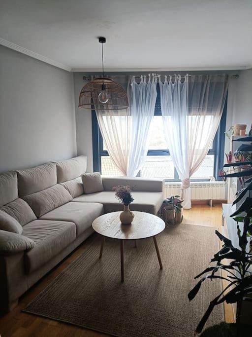 ein Wohnzimmer mit Sofa und Tisch in der Unterkunft Apartamento Sweet Carolinas in Vilagarcia de Arousa