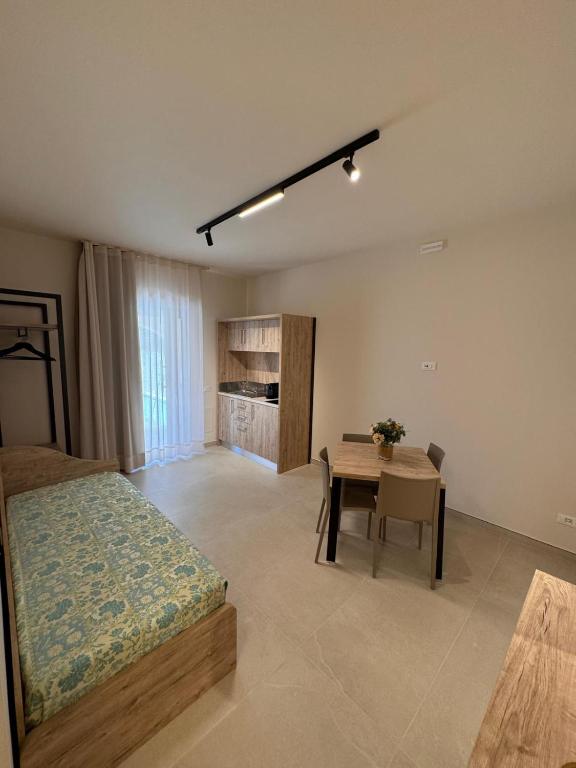 a bedroom with a bed and a table in it at Giglio di Mare Apartments in Rossano